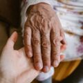 Close-up of elderly and young hands showing care and connection in Türkiye.
